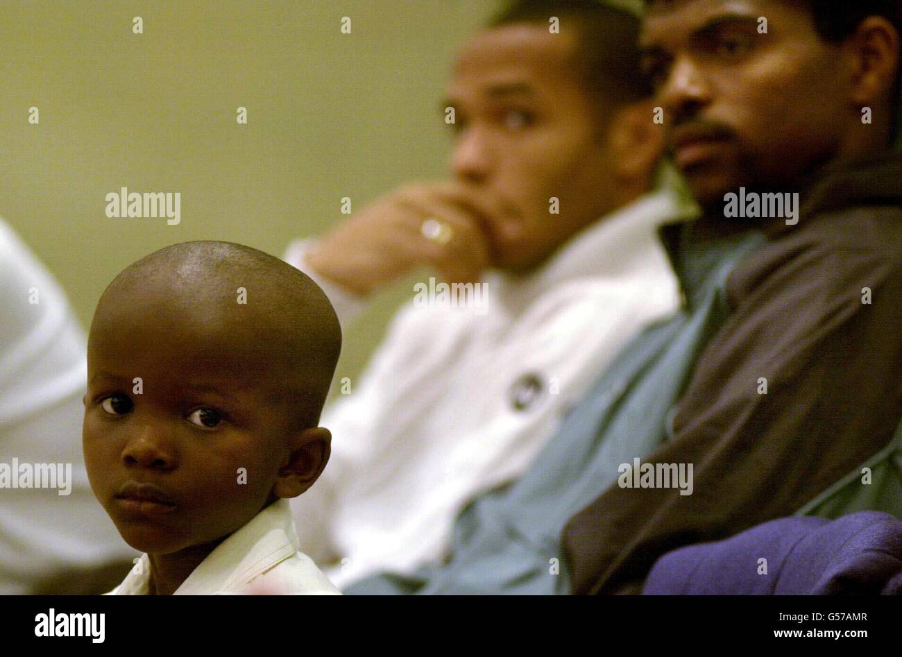 Arsenal soccer stars, Nwankwo Kanu (right) and Thierry Henry during a press conference in London to meet four-year-old Tofunmi Okude. Tofunmi was flown over from Nigeria for a livesaving heart operation, made possible through Kanu's Heart Foundation. Stock Photo