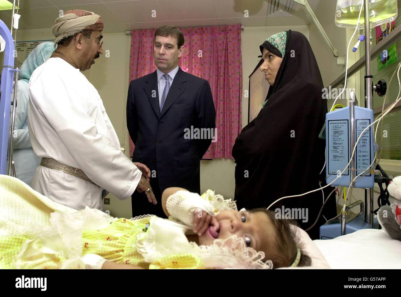 The Duke of York talks to the Doctor treating Mu'mina Khamis Saif, aged 16 months who is suffering from kidney failure, while her mother Fatma Hamad (R) looks on at the Sultan Qaboos University Hospital, just outside the capital Muscat, in Oman. * The Duke is on a three day visit to the middle eastern country for the sultan's 30th Anniversary. Stock Photo