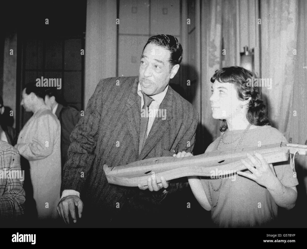 American bandleader Duke Ellington with fellow passenger Gina Glaser, 21, from New York, onboard the French Line's 'Ile de France' arriving at Plymouth, where the Duke is touring the British Isles with his band. Stock Photo
