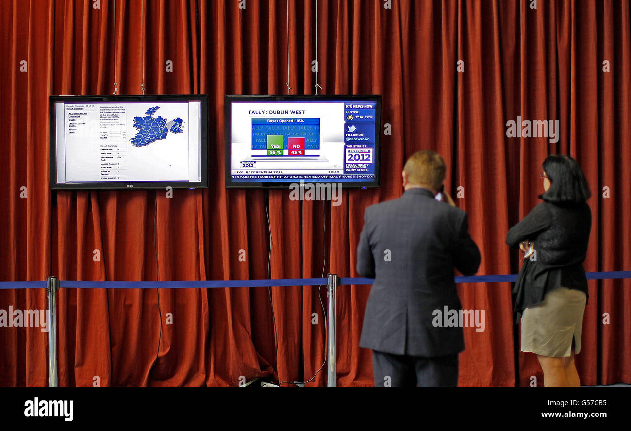 People watch screens in the Dublin count centre showing a likely yes vote in the Fiscal Stability Referendum as the votes are counted. Stock Photo