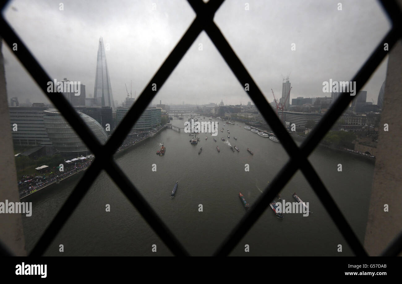 A view through a window in Tower Bridge as boats take part during the Diamond Jubilee River Pageant. Stock Photo