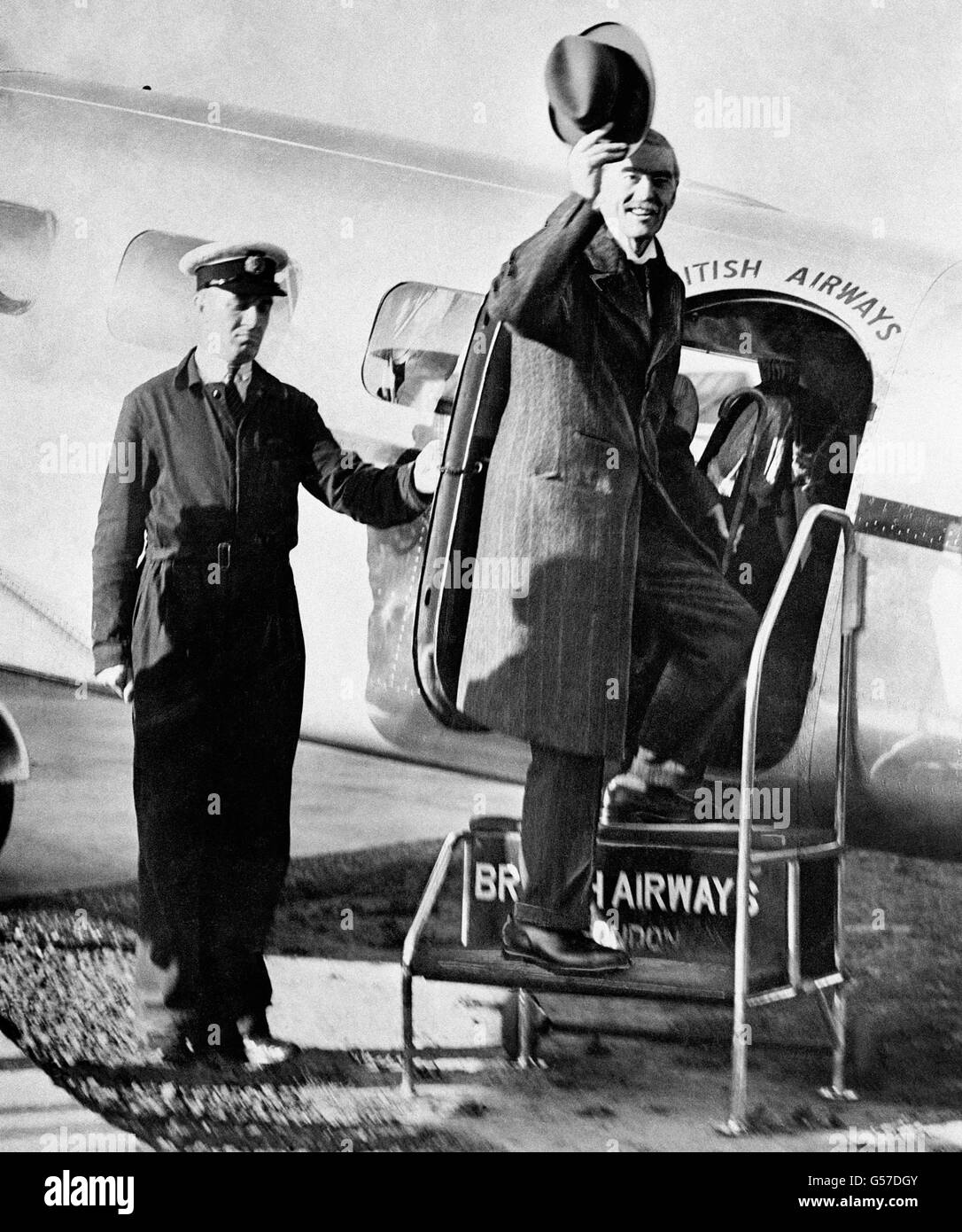 British Prime Minister Neville Chamberlain waves his hat as he boards an aircraft bound for Munich where he is to have talks with the German Fuhrer, Adolf Hitler, over the future of the disputed Czech Sudetenland. Stock Photo