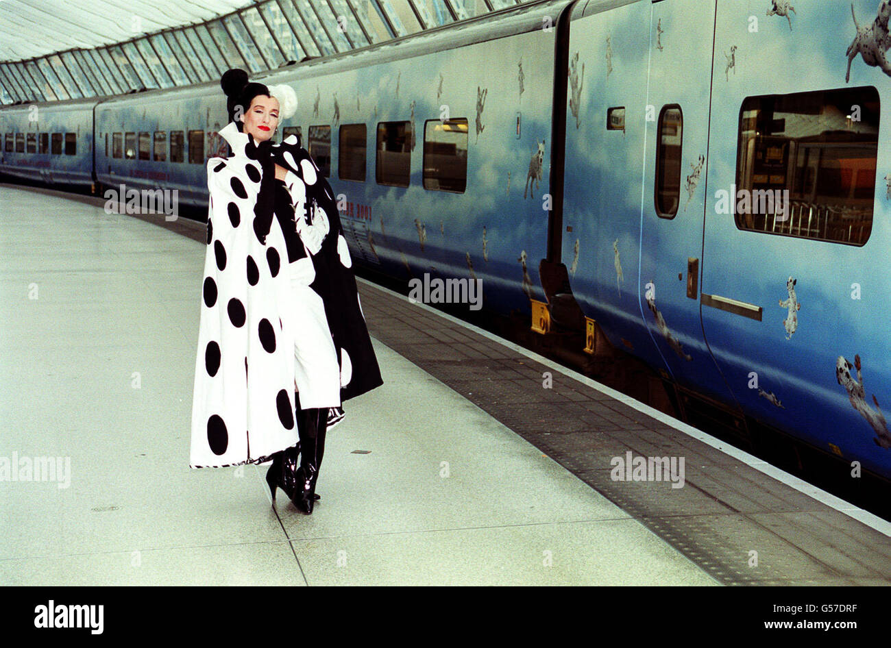 Cruella DeVil at Waterloo Station in London to launch Disney's 102 Dalmations Eurostar train. All 18 coaches of the train are covered with images of Dalmation puppies and the train will be in service on the Brussels, Paris and Disneyland Paris routes. Stock Photo