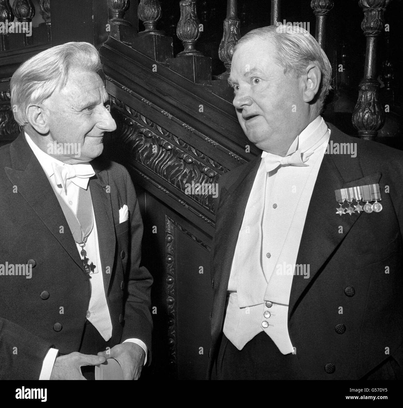 Poet Edmund Blunden (left) and author Evelyn Waugh enjoy a conversation at Skinners' Hall, London, when they received their scrolls as Companions of Literature, an honour to which they were elected by the Royal Society of Literature. Stock Photo