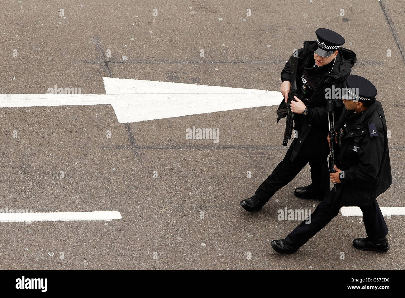 Armed police patrol outside the houses of parliament in london hi-res ...