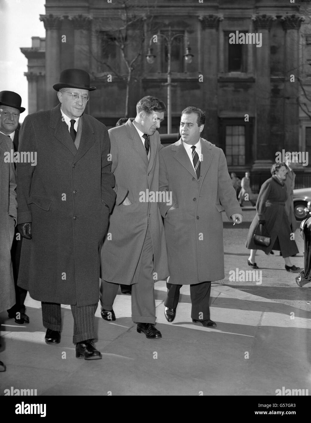 Tottenham Hotspur footballer Danny Blanchflower (c), whose brother Jackie was injured in the Munich plane crash, leaves St. Martin-in-the-Fields with Italian football agent Gigi Peronace (r) and Austrian sports journalist Dr Willy Meisl (l). Flight 609 which was carrying Manchester United players and officials as well as other passengers crashed on its third attempt to take off from a slush-covered runway at Munich-Riem Airport in Munich, resulting in a total of 23 fatalities with 21 survivors. Stock Photo