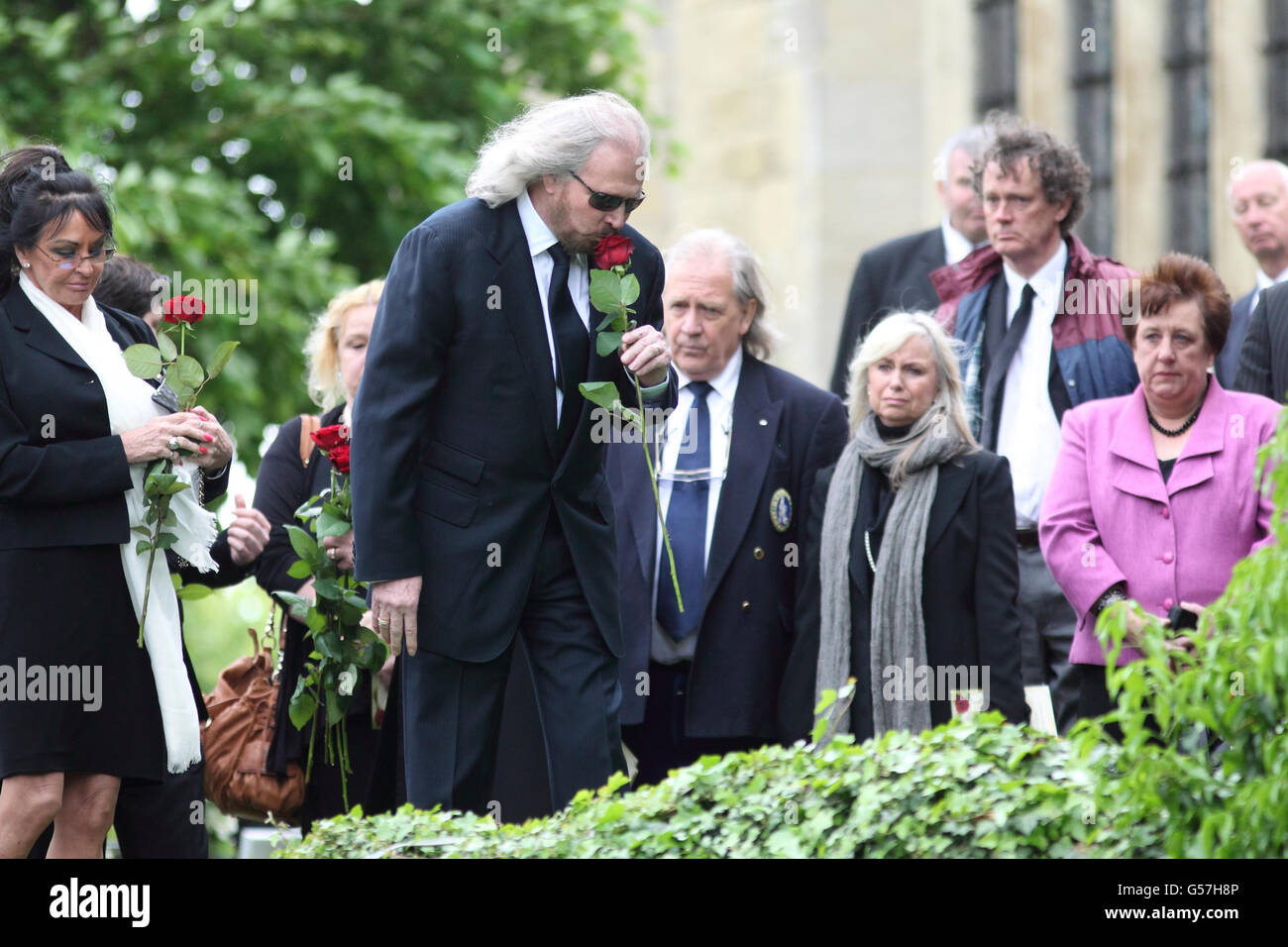 Bee Gee Barry Gibb lays a rose at the funeral of his brother Robin Gibb at St Mary's Church in Thame, Oxfordshire. Stock Photo