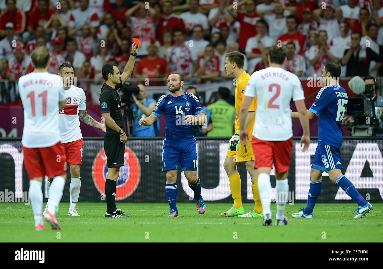 Referee Carlos Velasco Carballo (3rd left) shows Poland goalkeeper