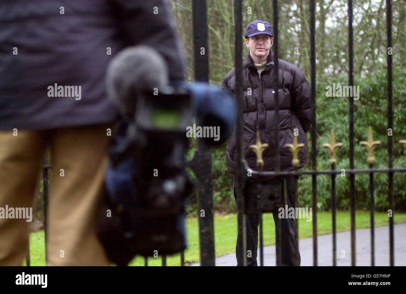 A TV cameraman stands at the gates of Skibo Castle in Scotland, where the wedding of Madonna and Guy Ritchie is taking place. Stock Photo