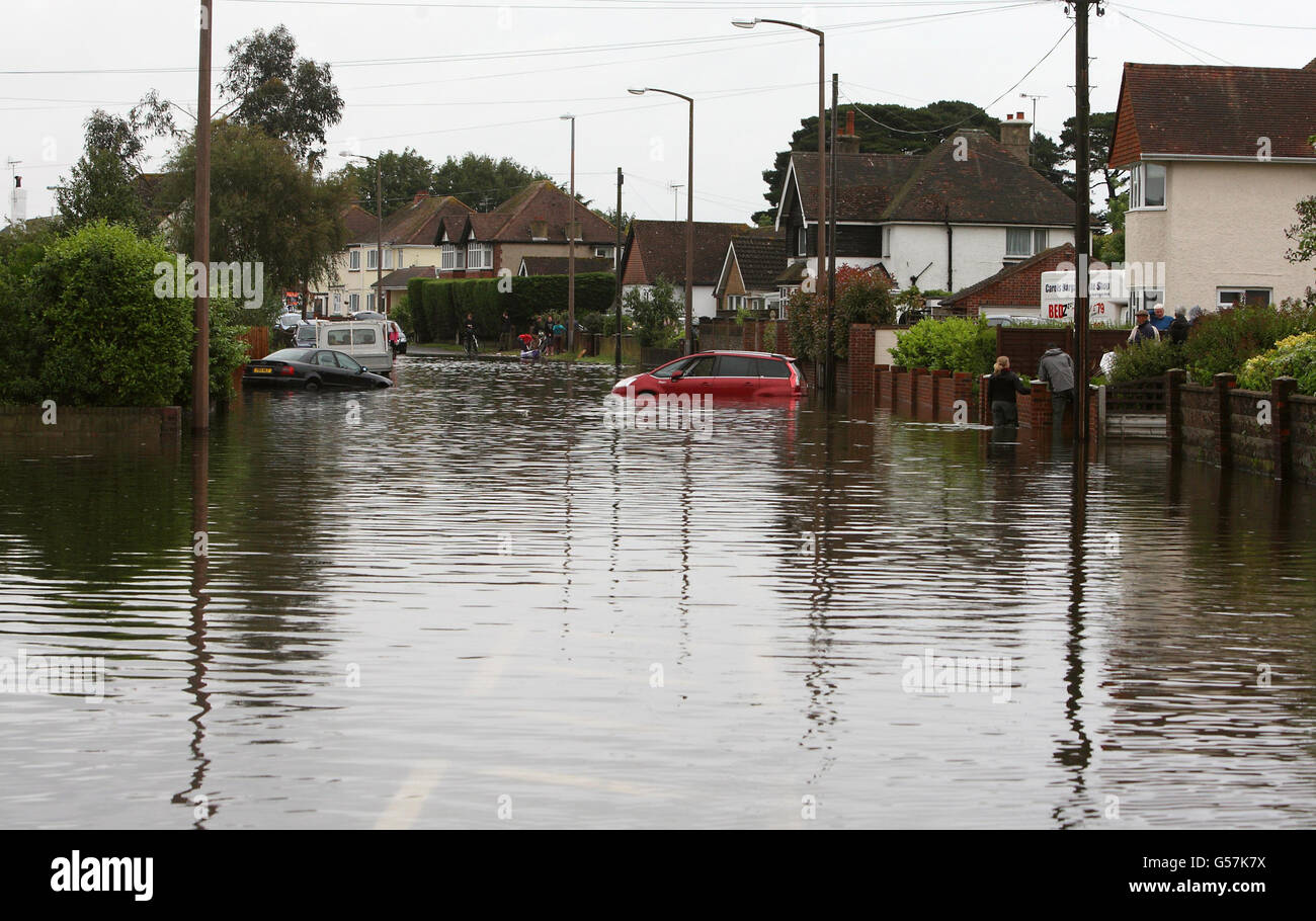 A general view of a flooded road in Felpham near Bognor Regis in West Sussex, after the South East and mid Wales were worst hit by the rain which has battered Britain. Stock Photo