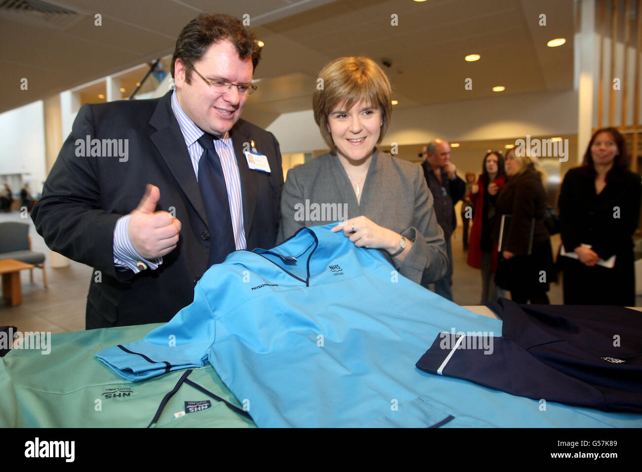 Health Secretary Nicola Sturgeon talks to Director of Nursing Rory Farrelly (l) during a visit to the New Stobhill Hospital in Glasgow to launch of the new NHS Scotland national uniforms Stock Photo