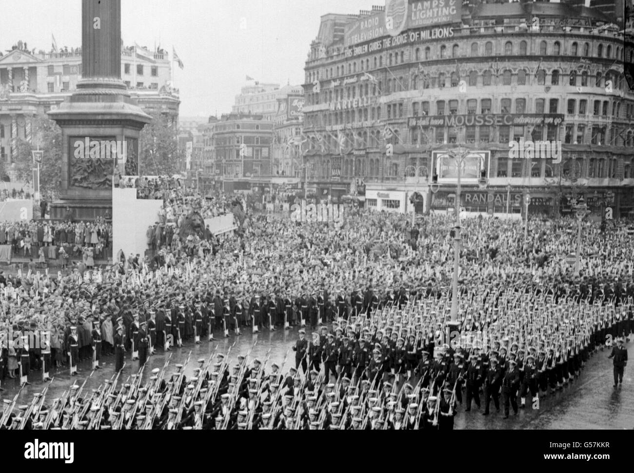 The Royal Navy detachment passes Nelson's Column in Trafalgar Square on the march from Westminster Abbey to Buckingham Palace after the Coronation of Queen Elizabeth II. Stock Photo