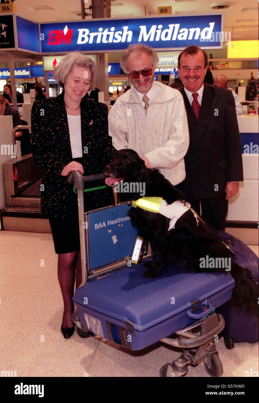 (L-R) Baroness Hayman, minister of State at MAFF, Mike Nussbaum and his guide dog Gretl and Rohan Alce, director of Cargo at Heathrow Airport in London. British Midland are celebrating the addition of Madrid and Brussels to their existing network covered under the pet travel scheme. * British Midland were the first UK airline to participate in the pet travel scheme and now operates the scheme to Amsterdam and Palma. Stock Photo