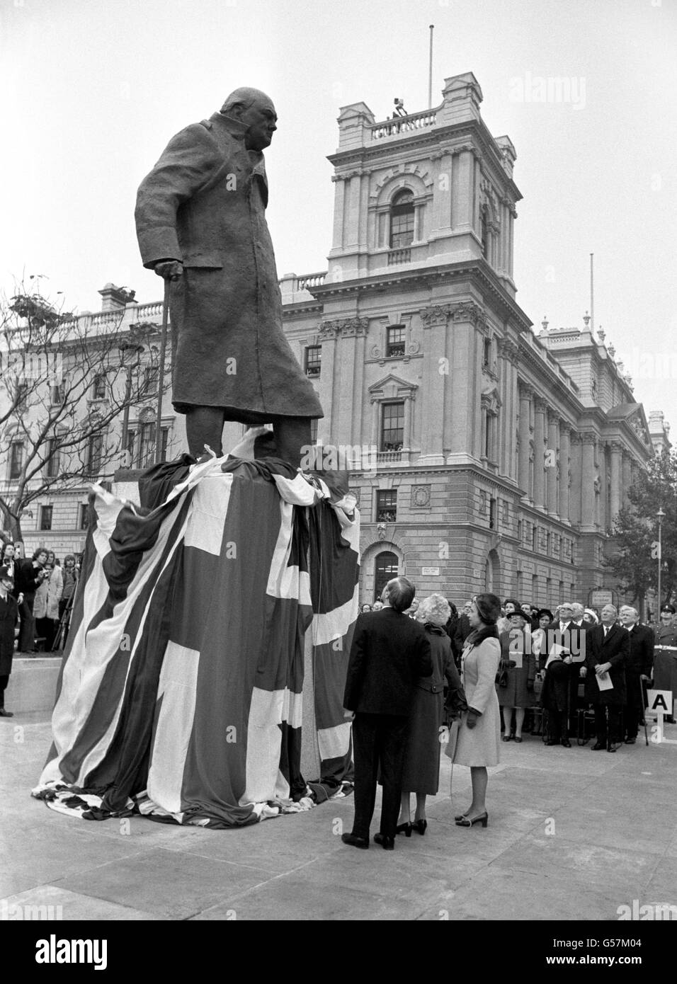 Queen Elizabeth II, with Baroness Spencer-Churchill and Winston Churchill MP, views the new bronze statue of Sir Winston Churchill after its unveiling by Lady Spencer-Churchill in Parliament Square. The 12ft figure, standing on a granite plinth, is the work of Ivor Roberts-Jones. Stock Photo