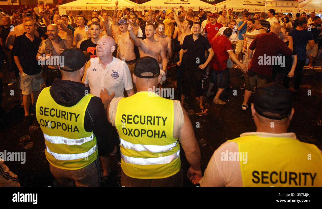 England fans surrounded by security to keep them away from Swedish fans in the fan zone in the centre of Kiev Stock Photo