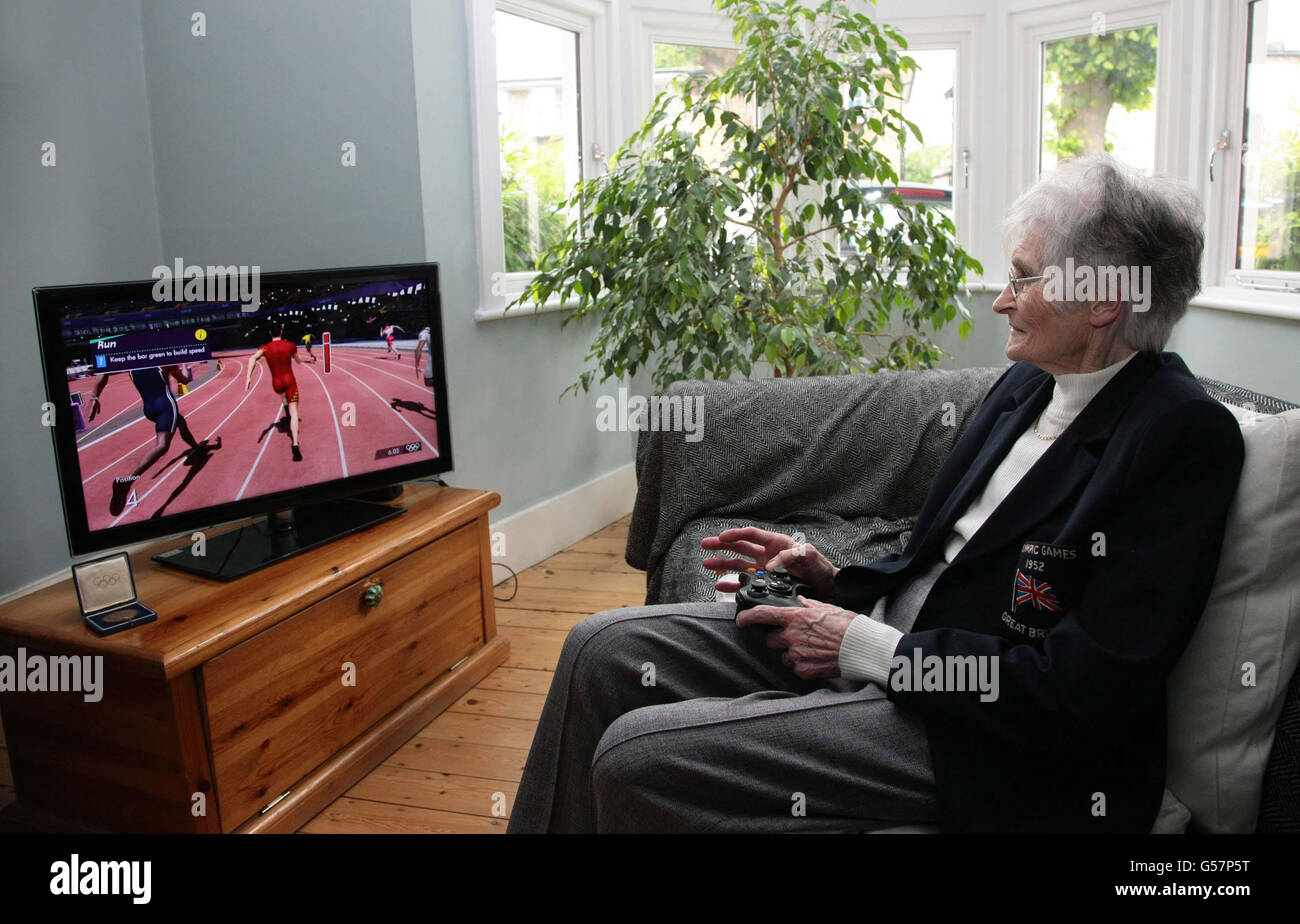 Jean Pickering aged 82 from Welwyn Garden City, one of the oldest living British Olympians and the proud winner of a bronze medal, while trying to beat her 100m personal best time from the 1952 Helsinki Olympics by previewing London 2012 - The Official Video Game of the Olympic Games which launches on 29th June. Stock Photo