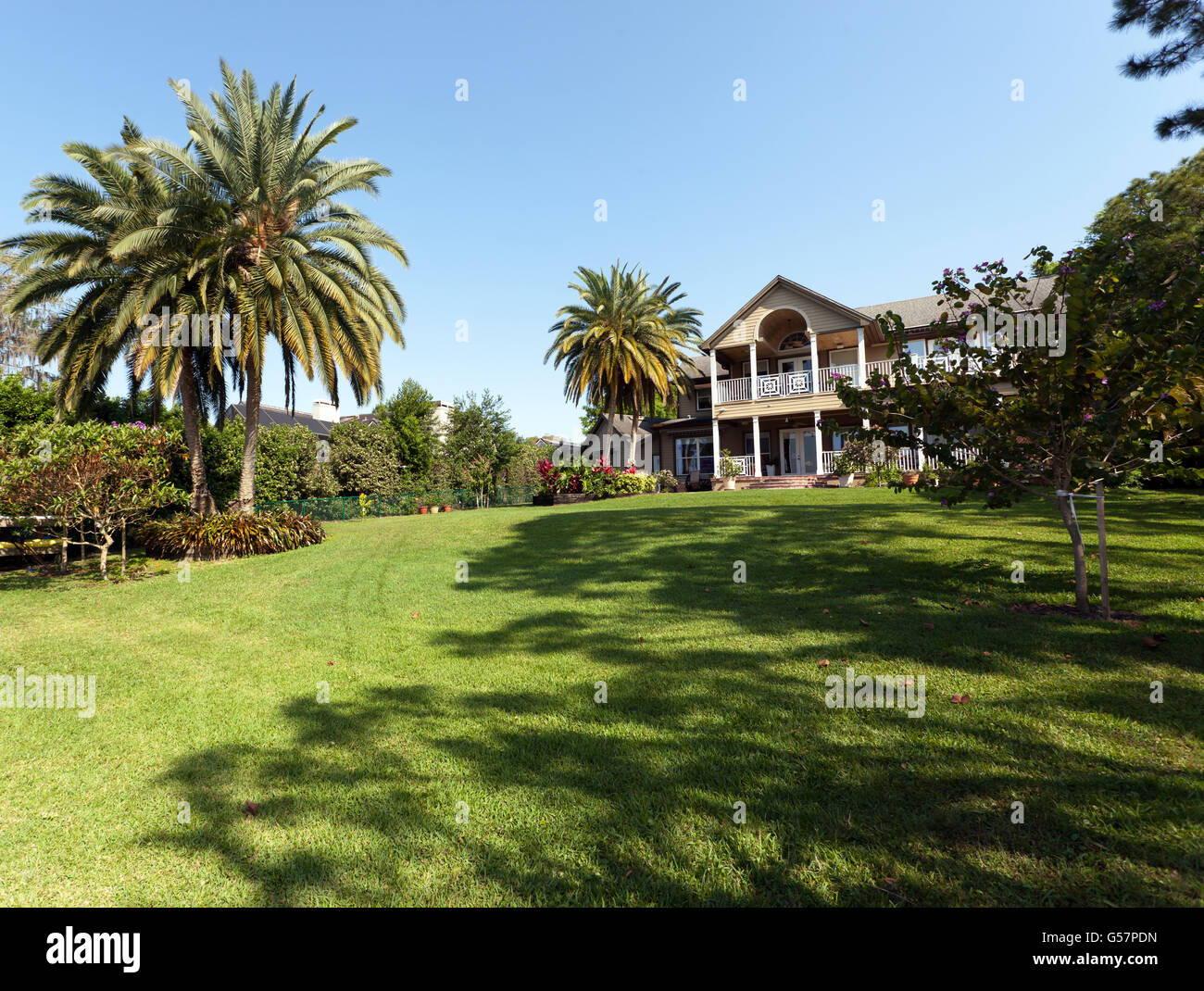View of the rear of a private, lakeside detached mansion at Lake