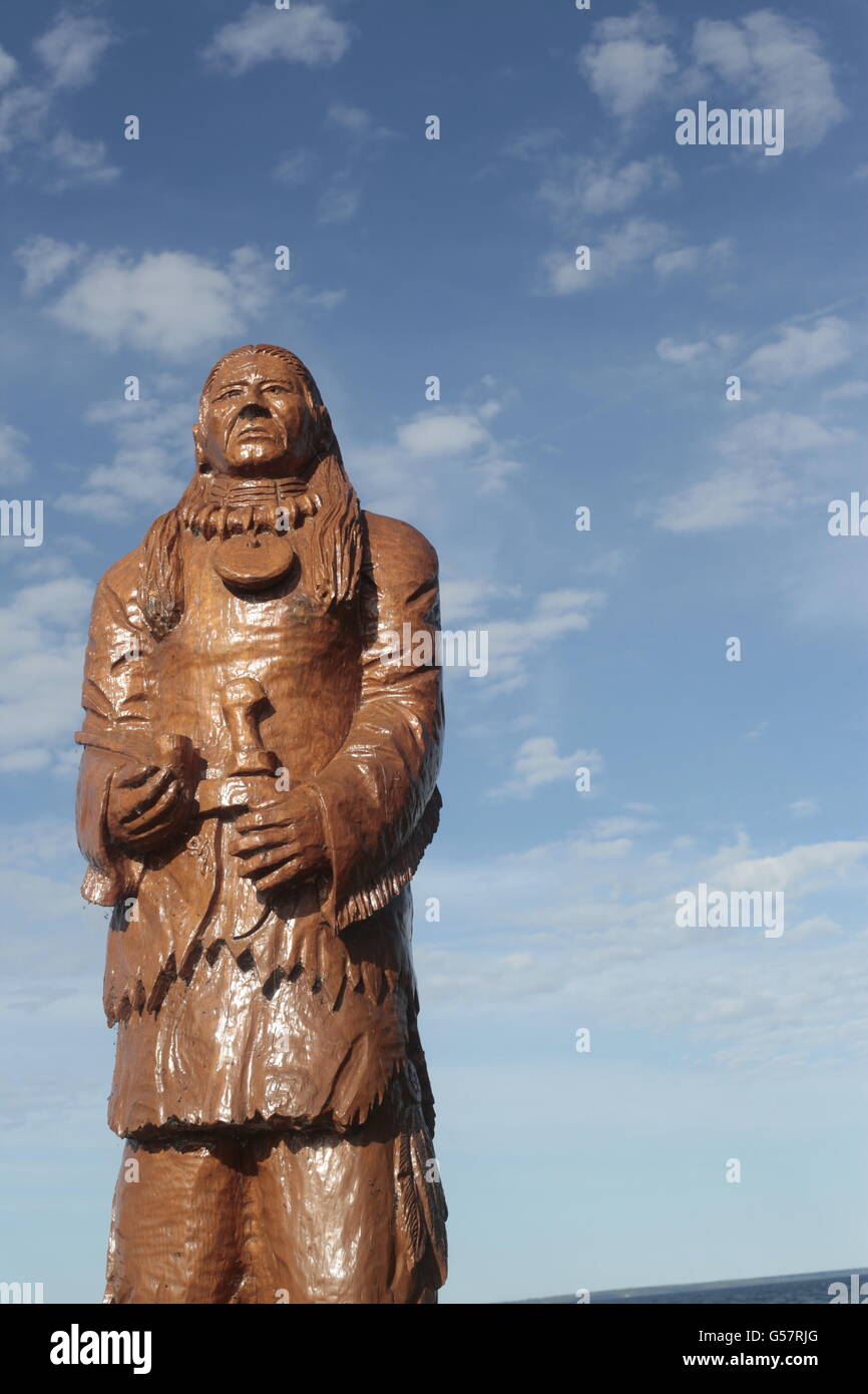 wooden Indian carving against blue sky Stock Photo