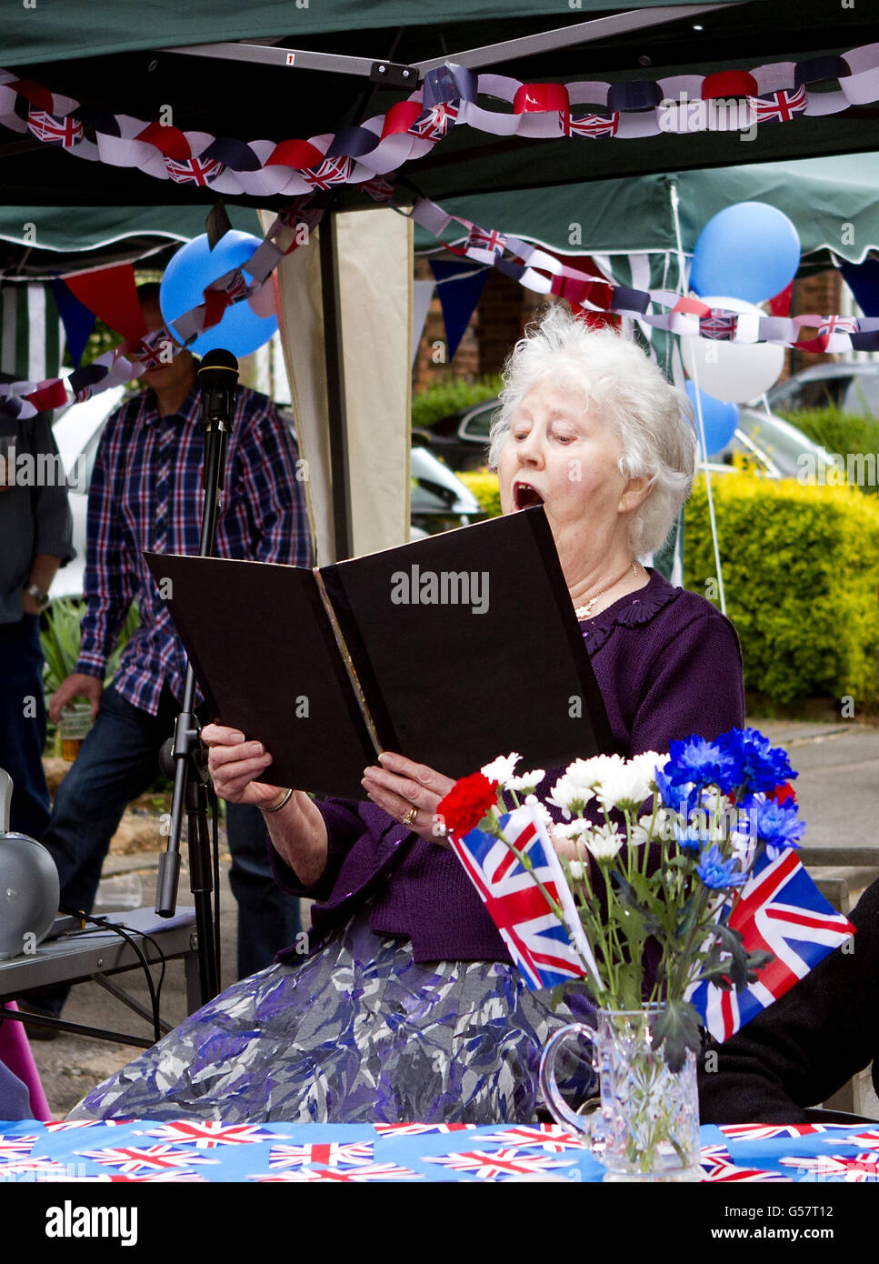 Local resident Jean Stevenson sings the national anthem for local TV