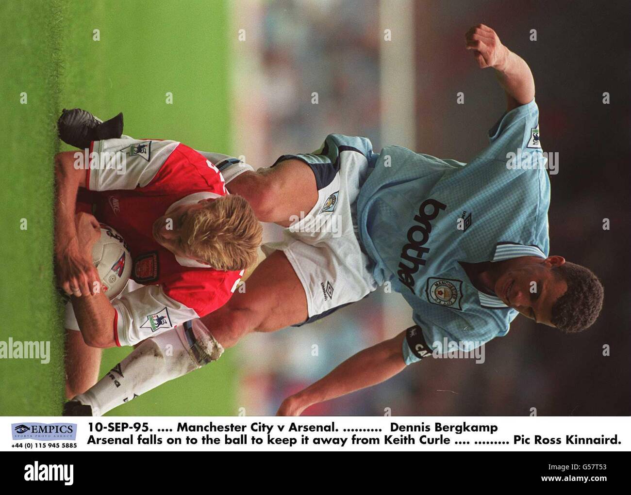 10-SEP-95. Manchester City v Arsenal. Dennis Bergkamp Arsenal falls on to the ball to keep it away from Keith Curle Stock Photo