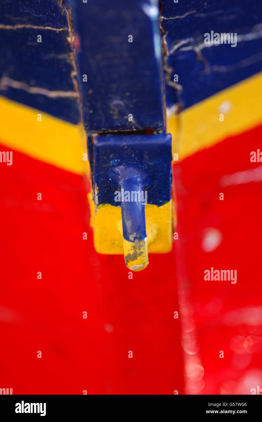 Weathered blue yellow and red painted fishing boat Stock Photo - Alamy