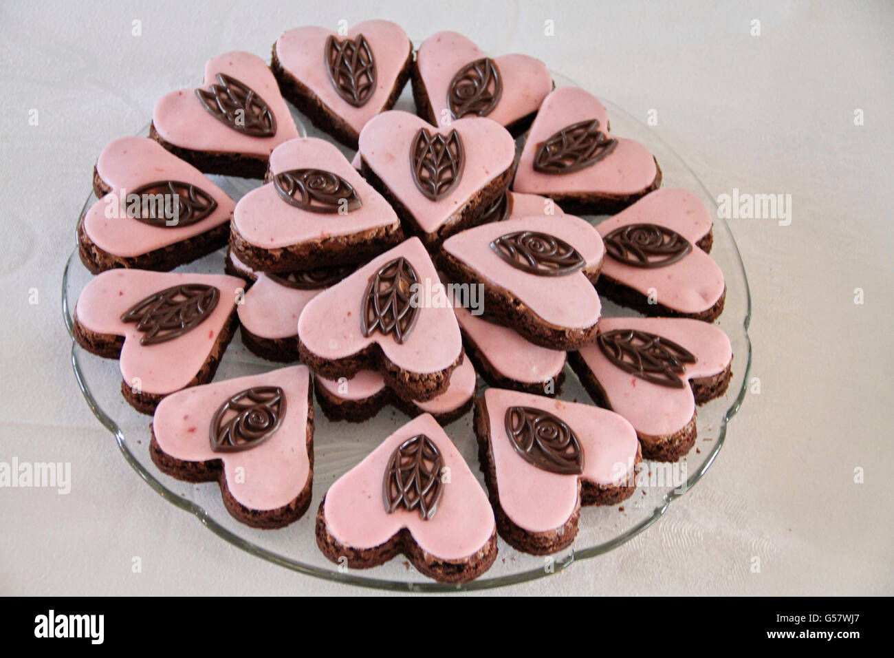 Delicious hart shaped chocolate cakes with pink glazing Stock Photo