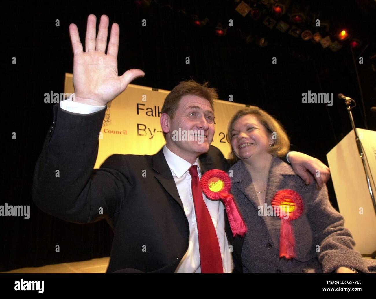 Politics with wife rosette red tie arms round hires stock photography