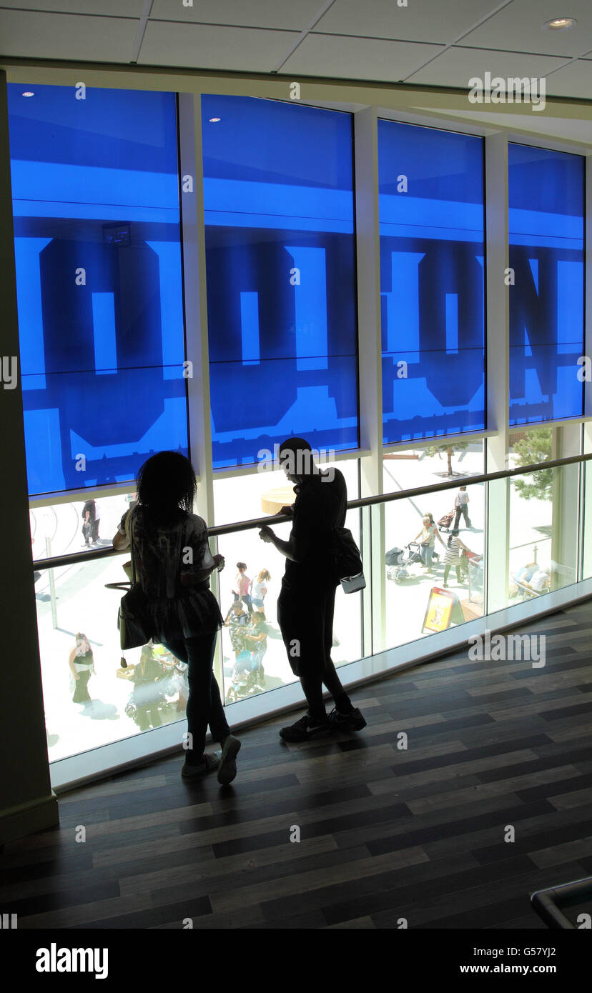 A couple look out from inside the Odeon Cinema, New Square, West Bromwich Stock Photo