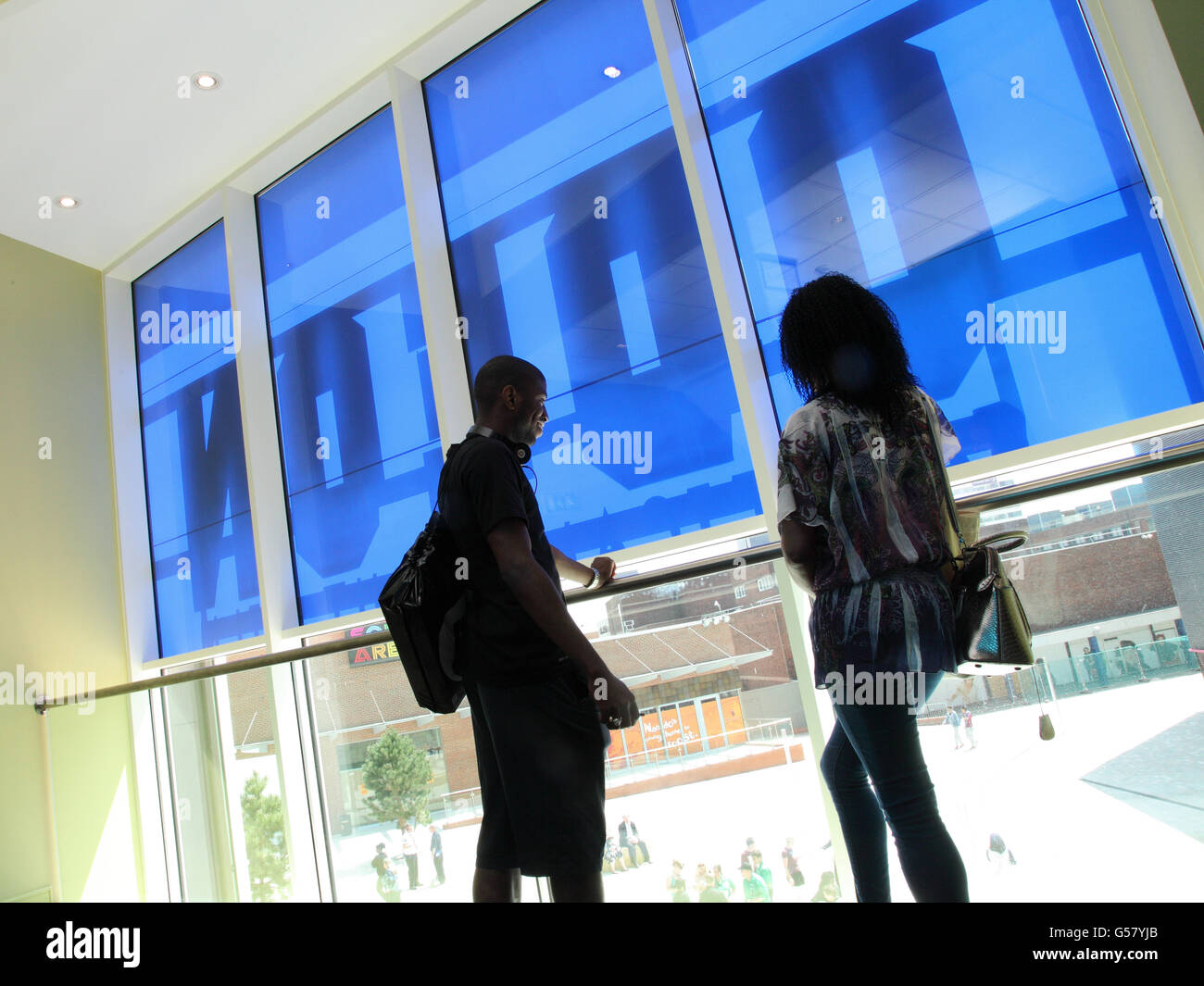 A couple look out from inside the Odeon Cinema, New Square, West Bromwich Stock Photo