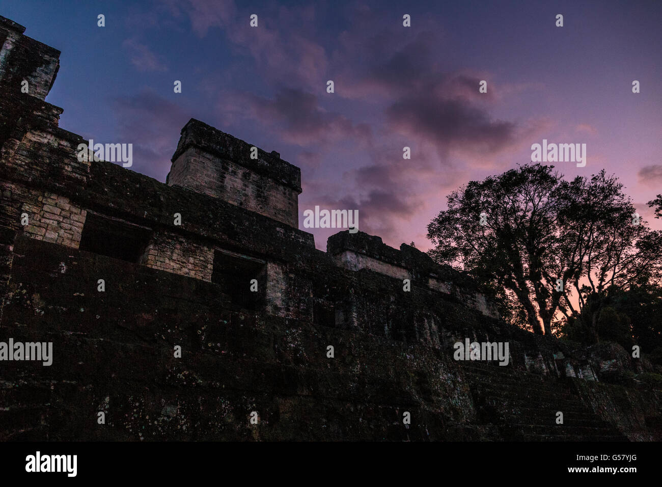 Dusk falls over Maler's Palace in the ancient Mayan ruins of Tikal, on the south side of the Great Plaza in northern Guatemala. Stock Photo