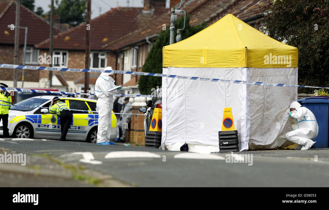 Police attend the scene in the Norris Green area of Liverpool after a man was shot dead. Stock Photo