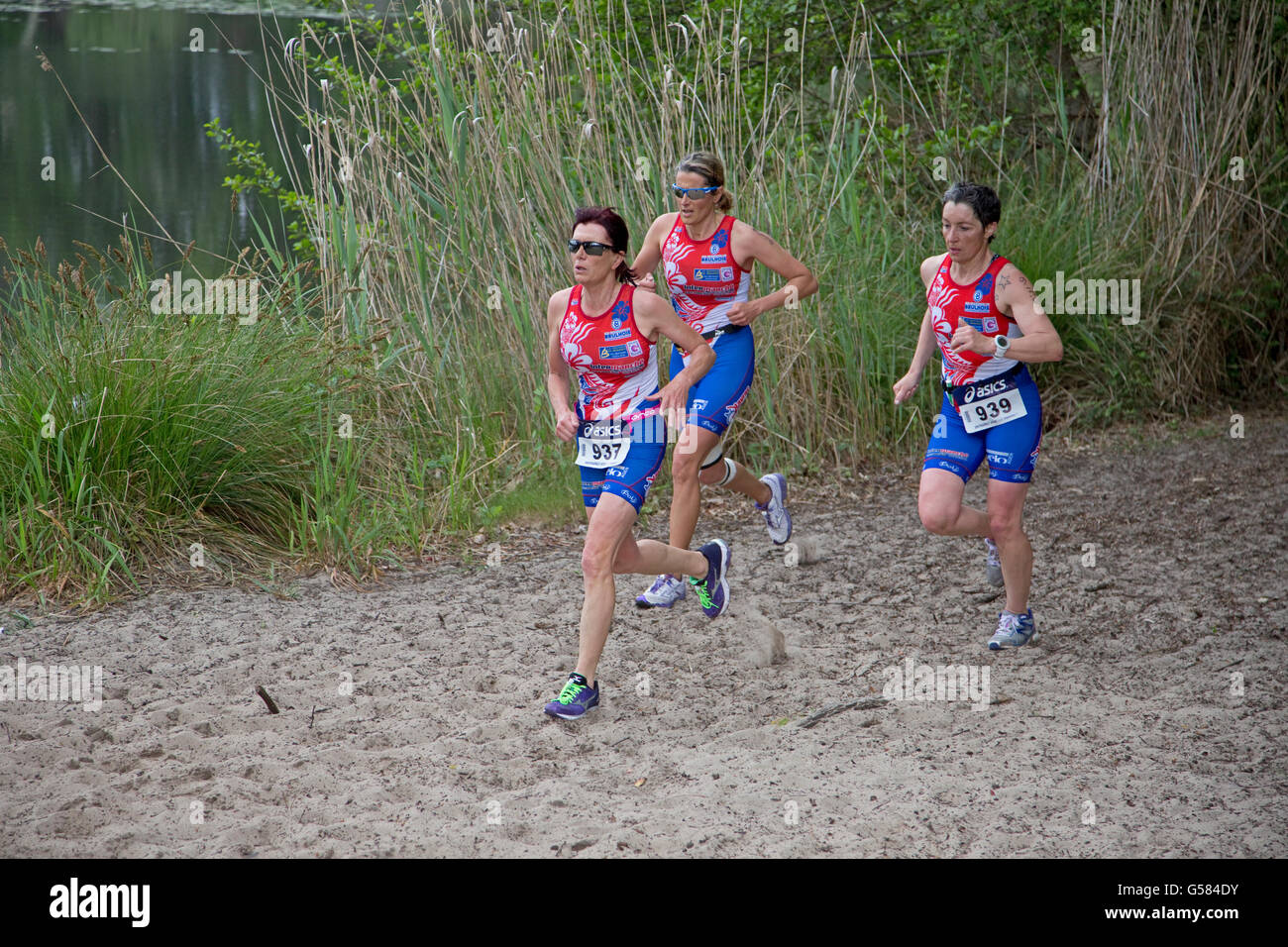 Team of three runners competing in Triathlon of Mimizam France Stock Photo