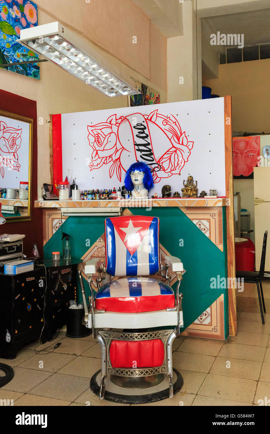 Hairdressing salon, barbershop and tattoo parlor interior with Cuban flag chair in La Habana Vieja, Havana, Cuba Stock Photo