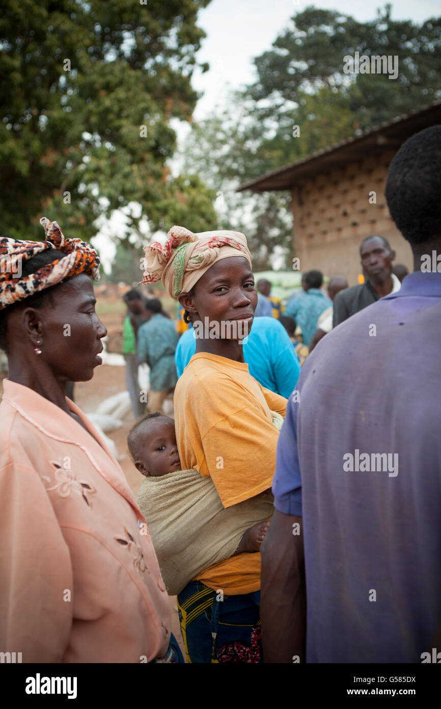 A woman carries her baby on her back in Banfora Department, Burkina Faso. Stock Photo