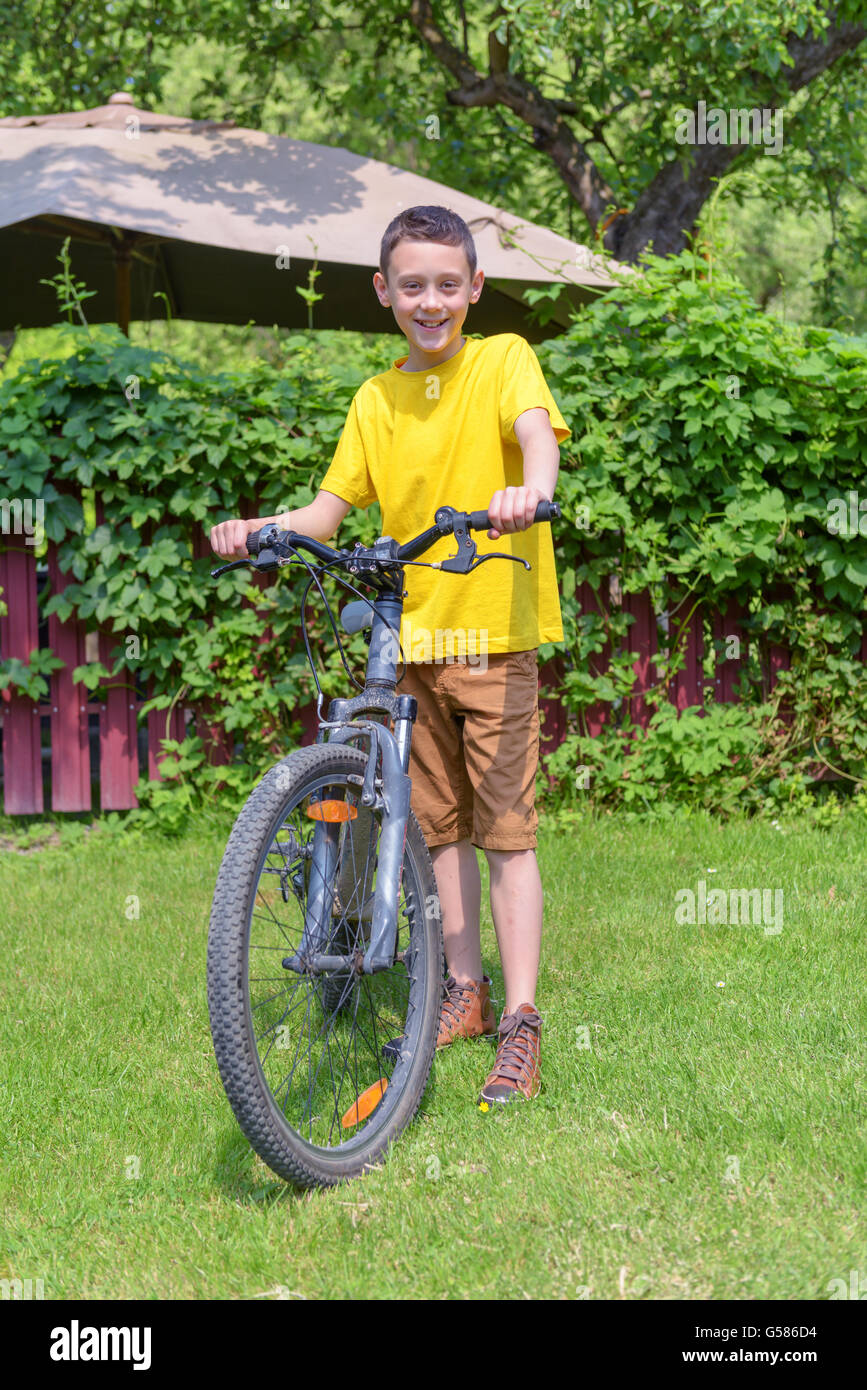 boy on bike in summer day Stock Photo