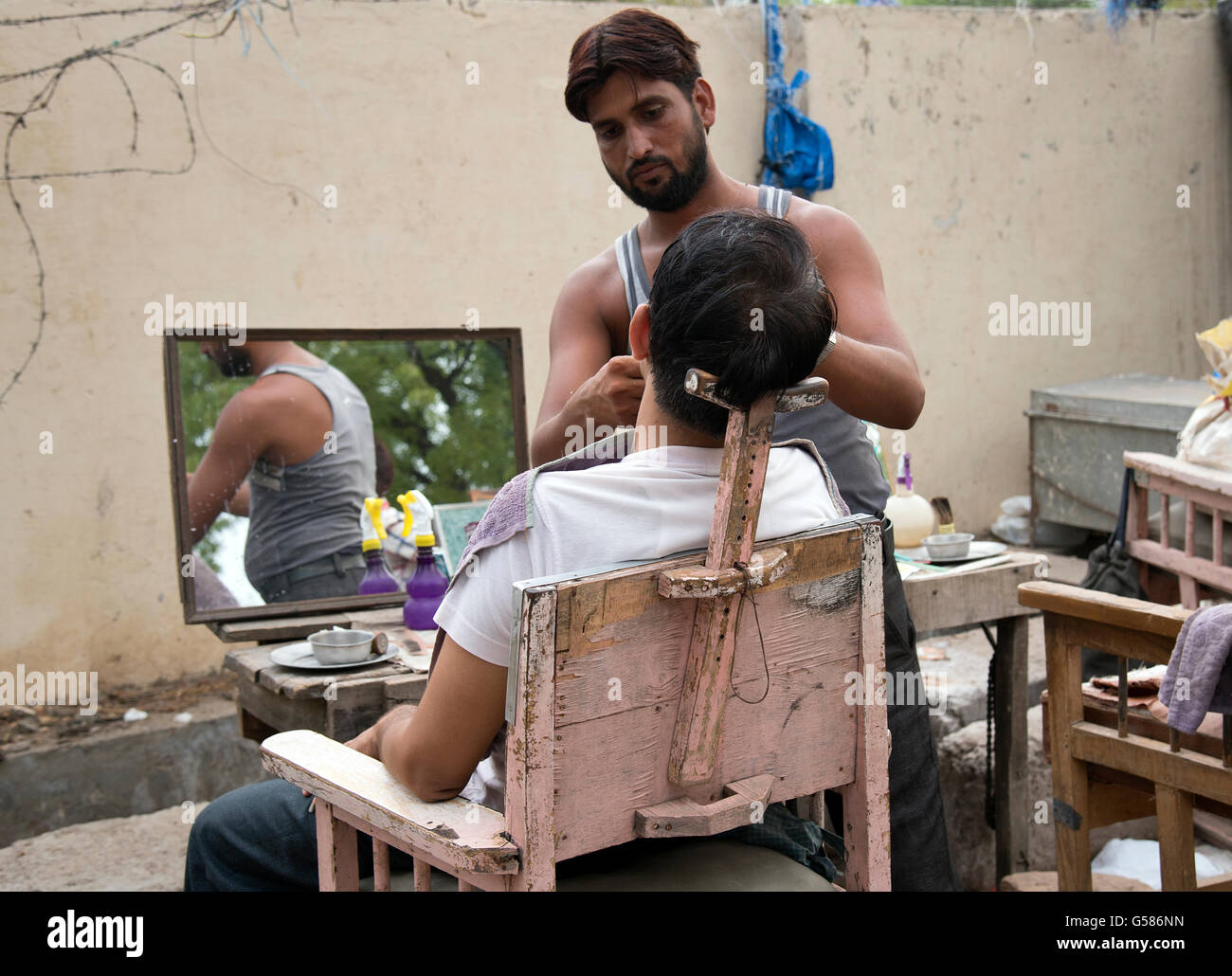 The image of Roadside Barber was taken in Sawai Madhopur in Rajasthan India Stock Photo