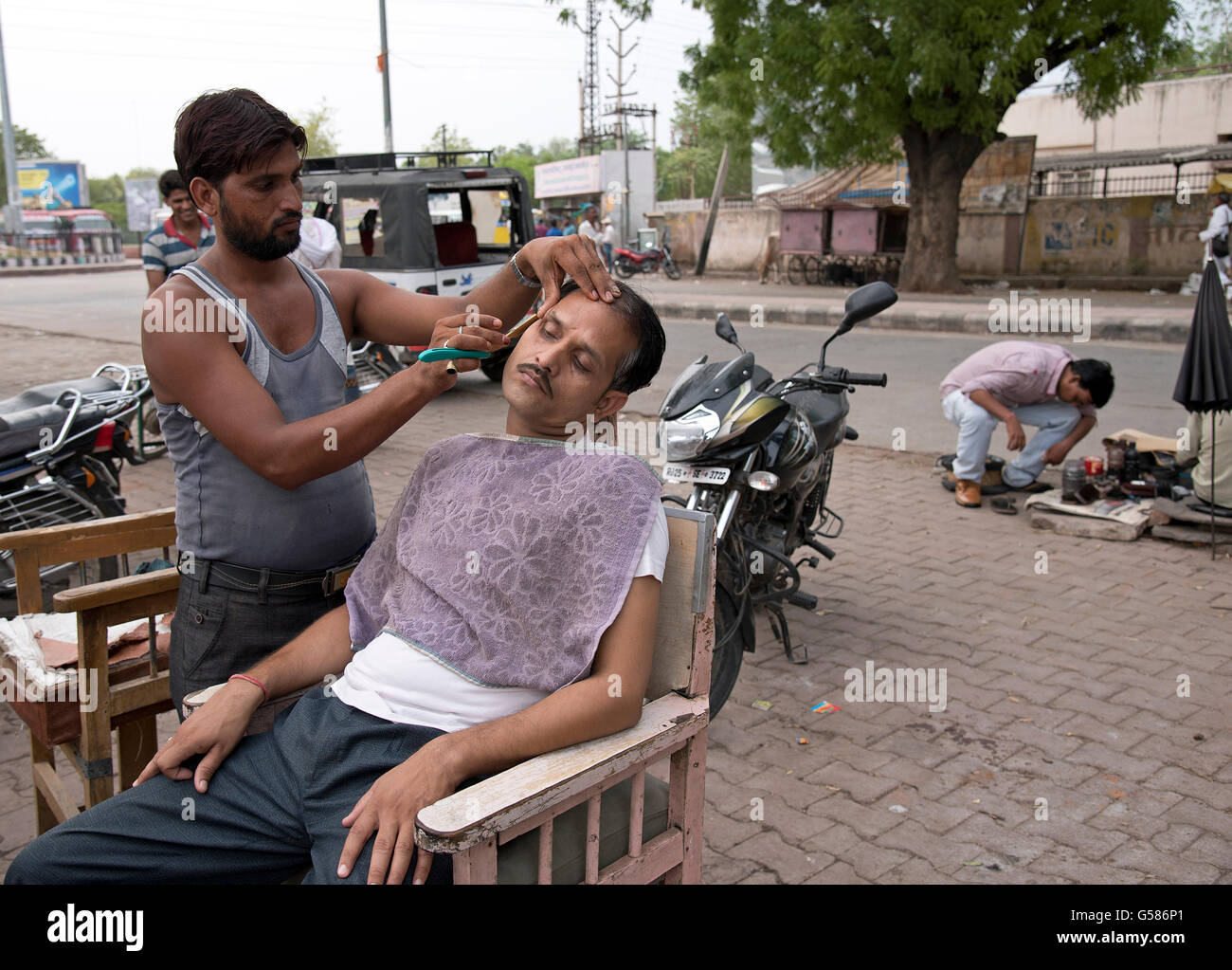 The image of Roadside Barber was taken in Sawai Madhopur in Rajasthan India Stock Photo