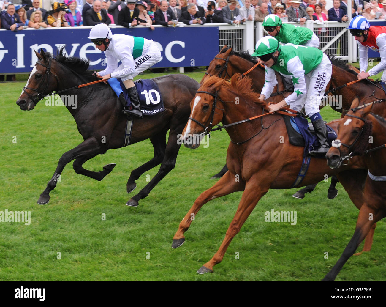 Gatewood (left) ridden by William Buick wins the Investec Wealth & Investment Stakes during Investec Ladies' Day of the Investec Derby Festival at Epsom Racecourse. Stock Photo