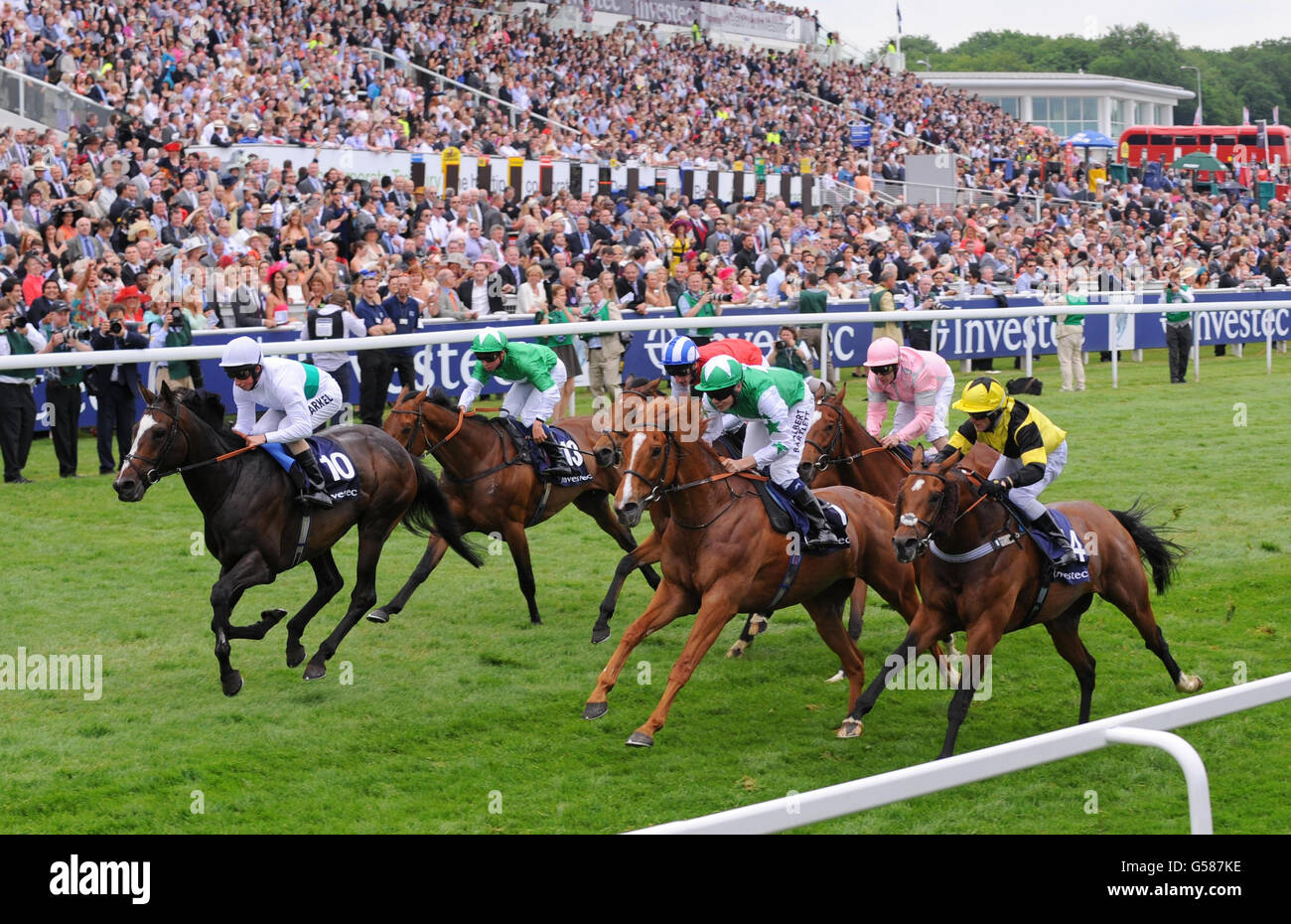 Gatewood (left) ridden by William Buick wins the Investec Wealth & Investment Stakes during Investec Ladies' Day of the Investec Derby Festival at Epsom Racecourse. Stock Photo