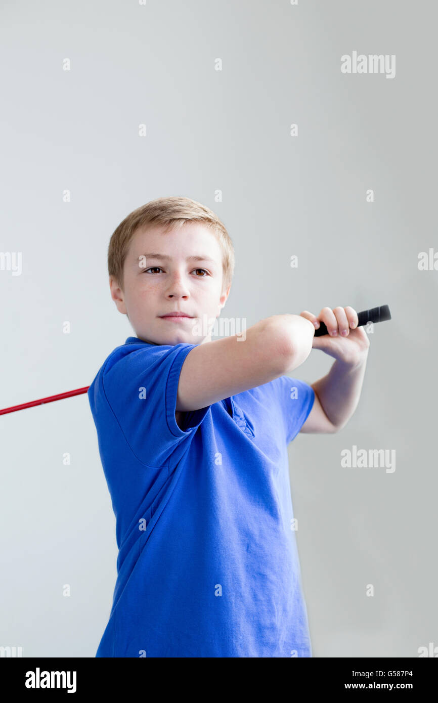 Young boy swinging a golf club Stock Photo