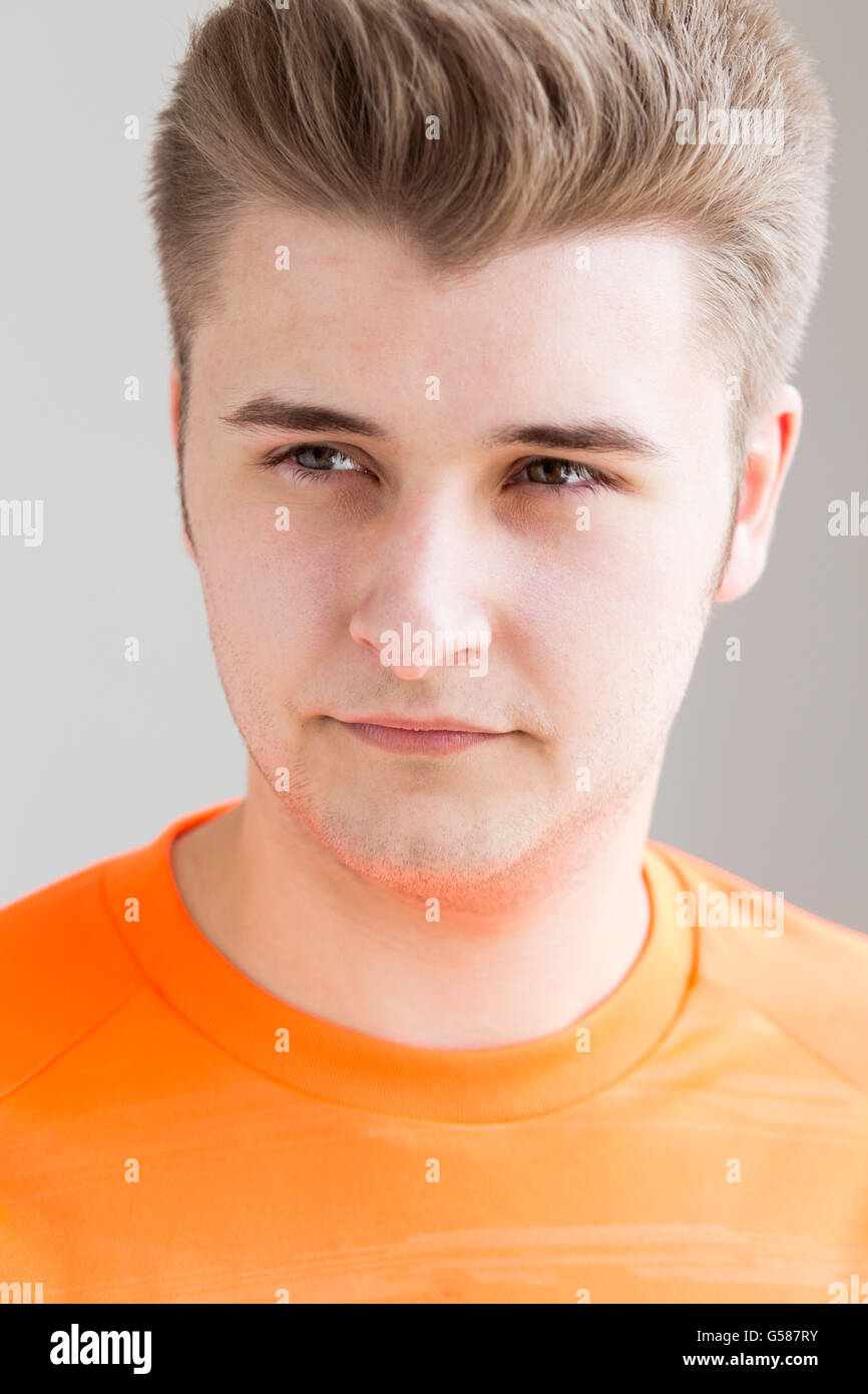 Close up portrait of an attractive young man against a plain background. Stock Photo