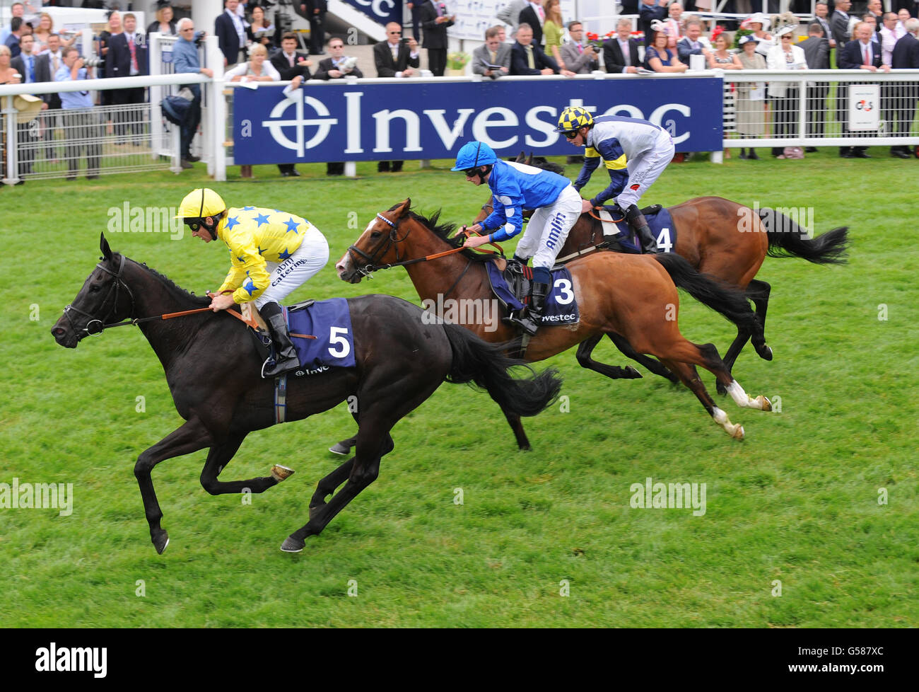 Side Glance (left) ridden by Jimmy Fortune, wins the Investec Diomed Stakes during Investec Ladies' Day of the Investec Derby Festival at Epsom Racecourse. Stock Photo