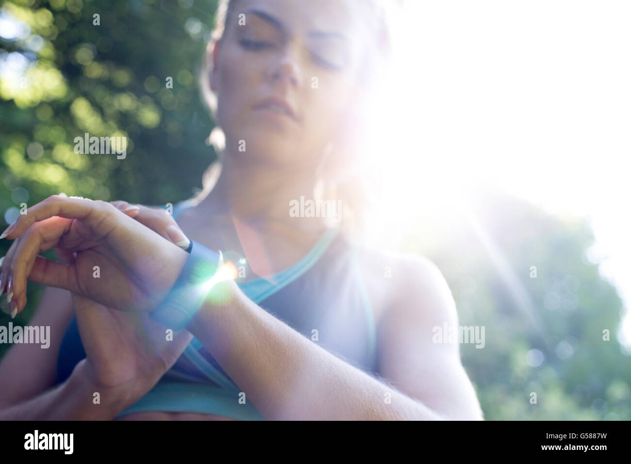 Young woman using a fitness watch Stock Photo