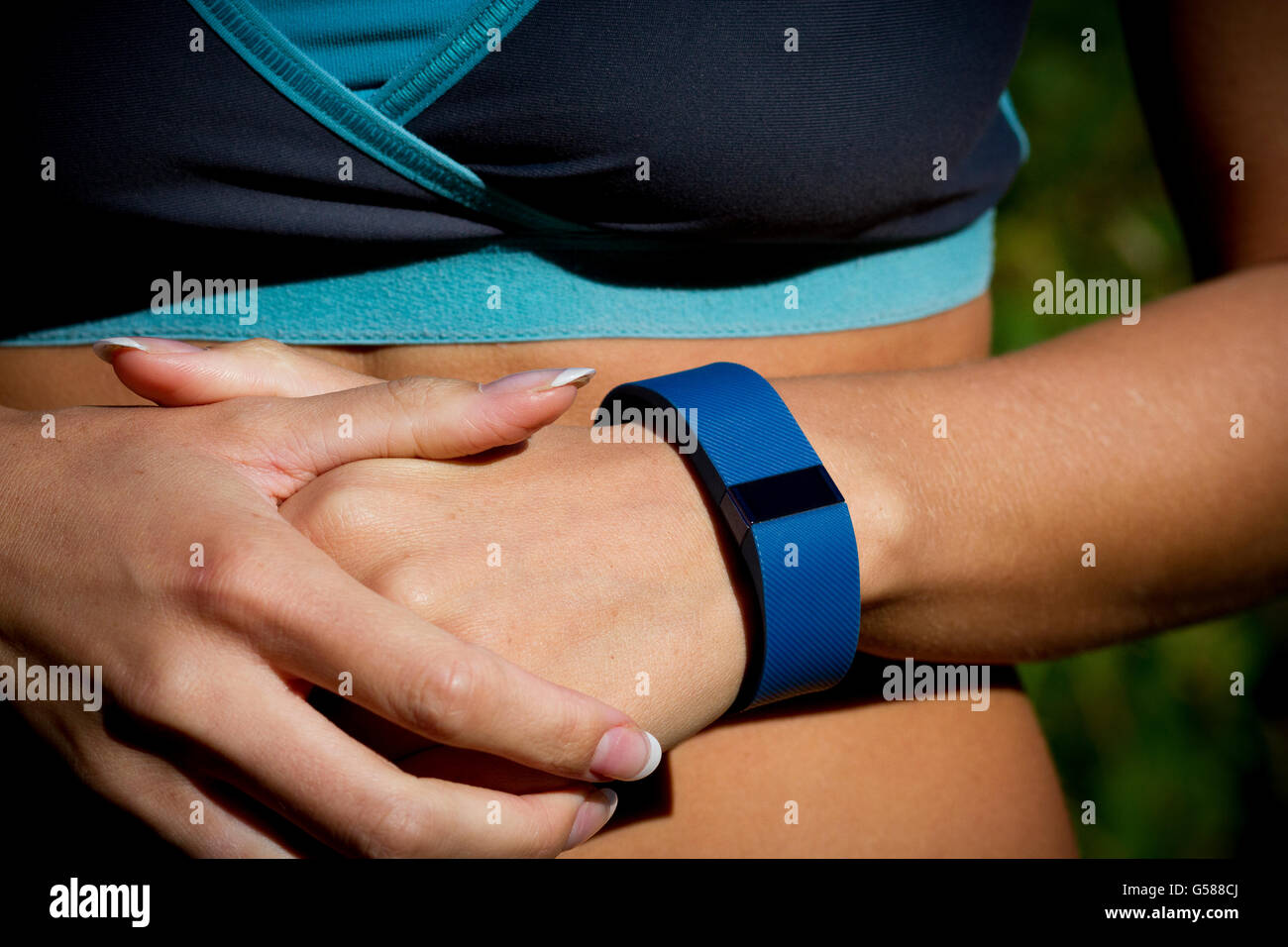 Young woman using a fitness watch during her run. Stock Photo