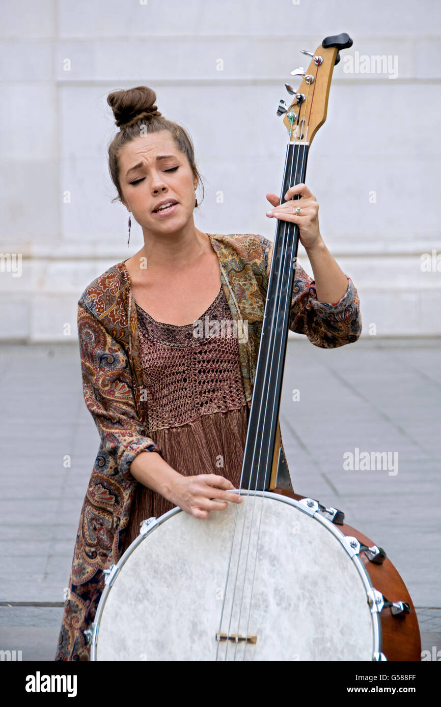 The bassist the team of Coyote & Crow playing a one of a kind homemade string bass in Greenwich Village, New York City Stock Photo