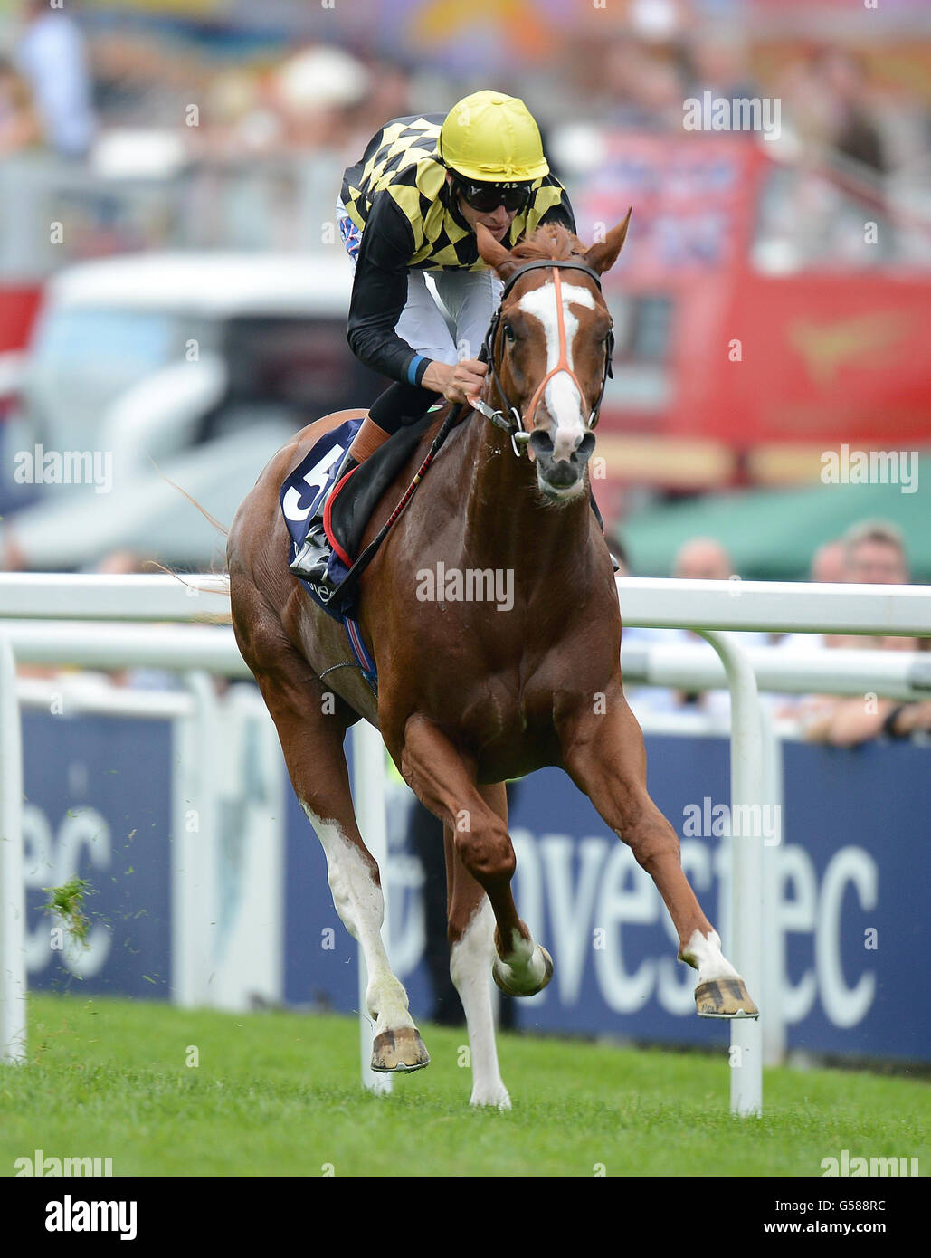 Producer ridden by Richard Hughes goes on to win The Investec Surrey Stakes during Investec Ladies' Day of the Investec Derby Festival at Epsom Racecourse. Stock Photo
