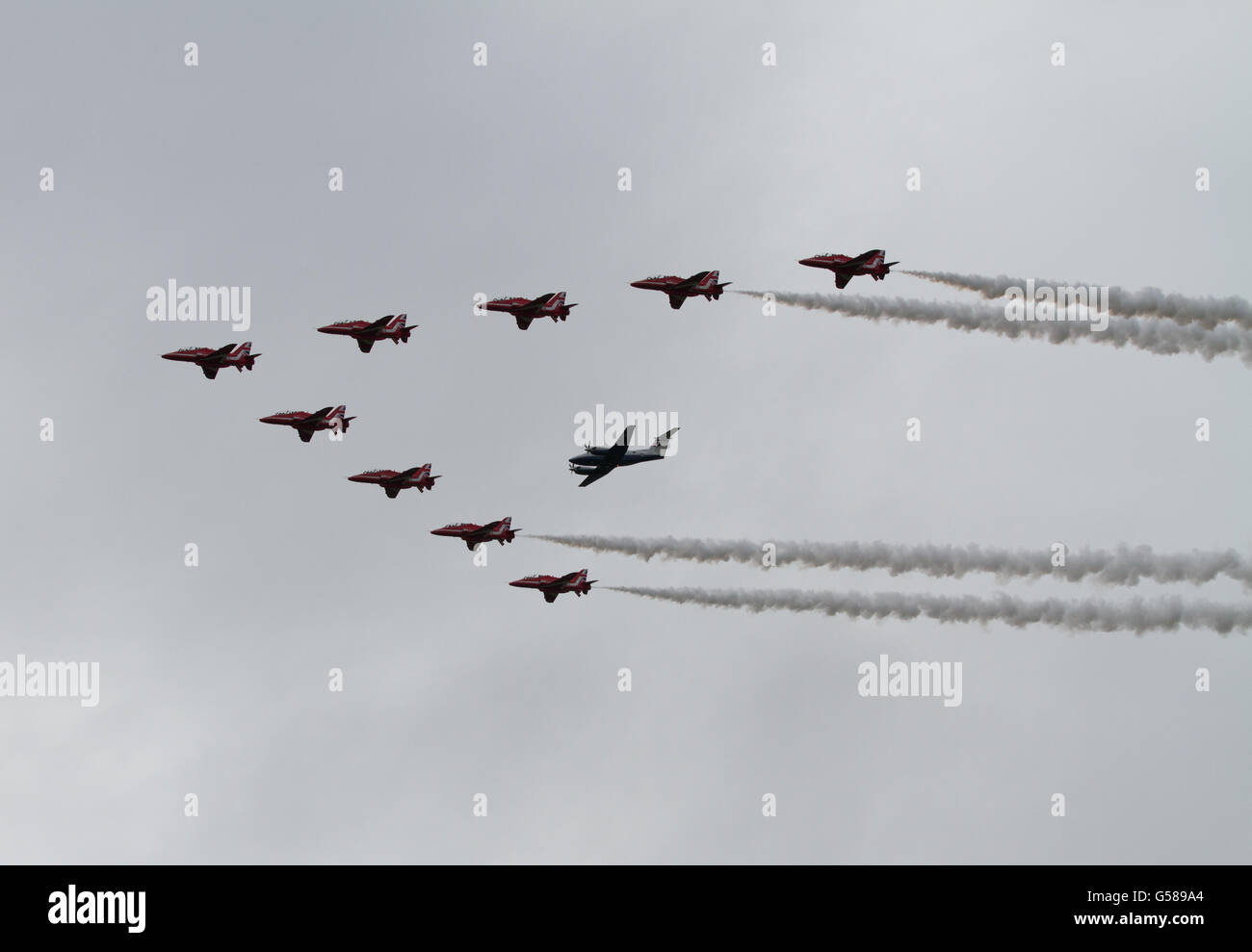 The RAF Red Arrows perform a flypast with RAF King Air passenger aircraft at Cosford Air Show Stock Photo