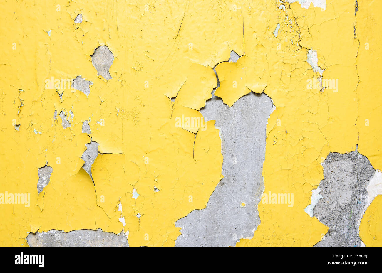 Old peeling yellow painted wall background texture Stock Photo