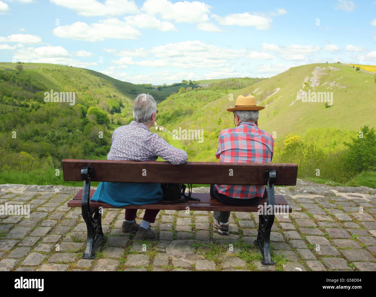 A senior male and female at Monsal Head overlooking views along the Wye Valley, Peak District National Park Derbyshire UK Stock Photo