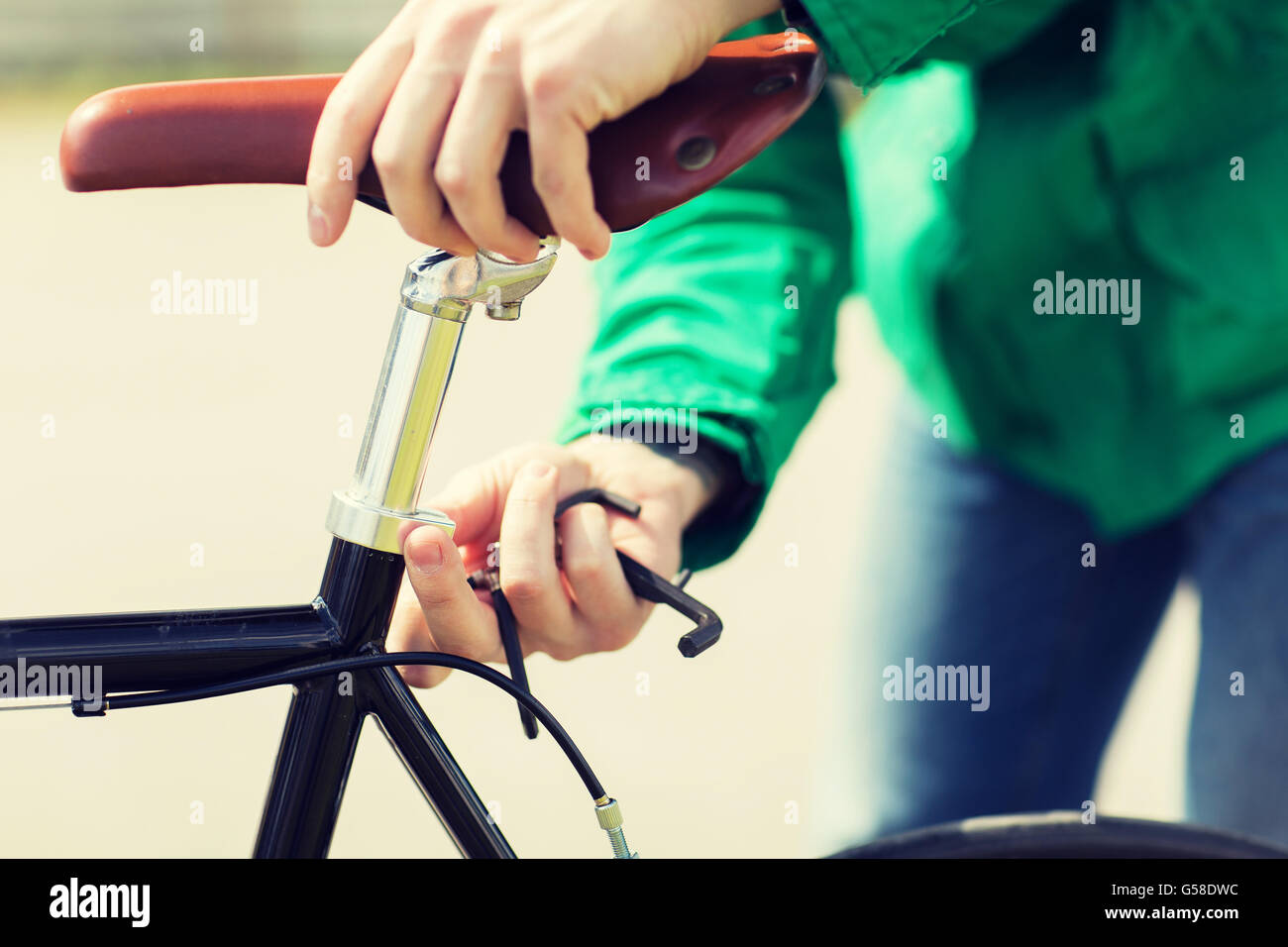 close up of man adjusting fixed gear bike saddle Stock Photo